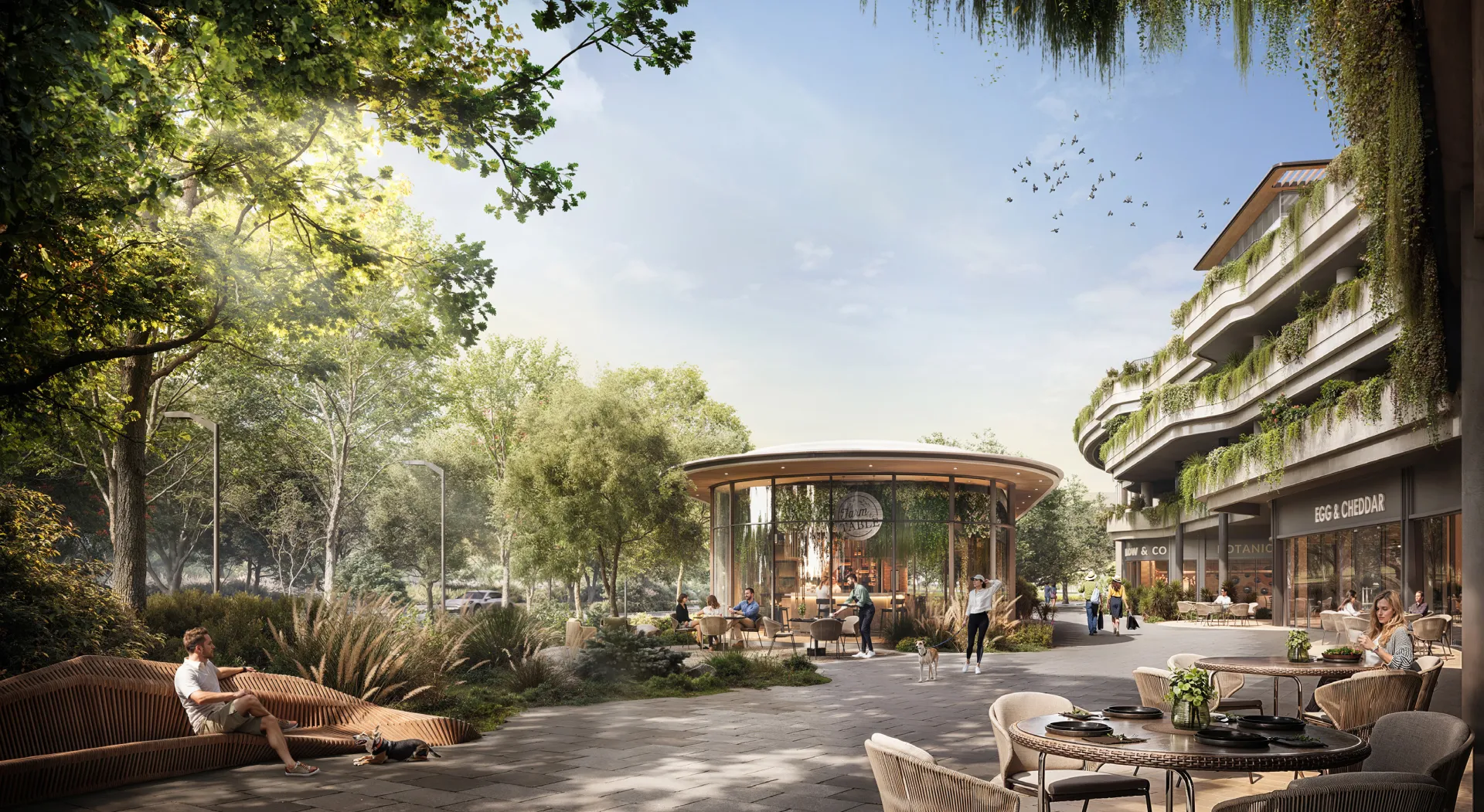 Tree-lined retail and dining promenade at the base of the DISTRIKT towers