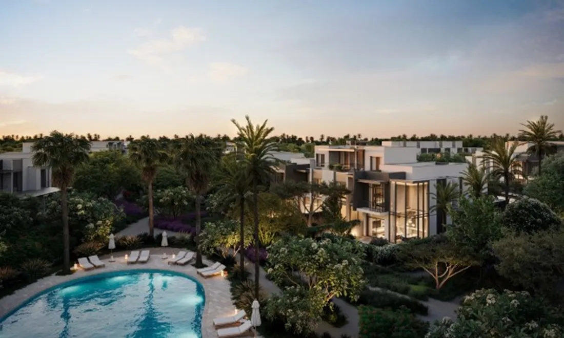 Community pool among palms and townhouses at dusk, La Tilia