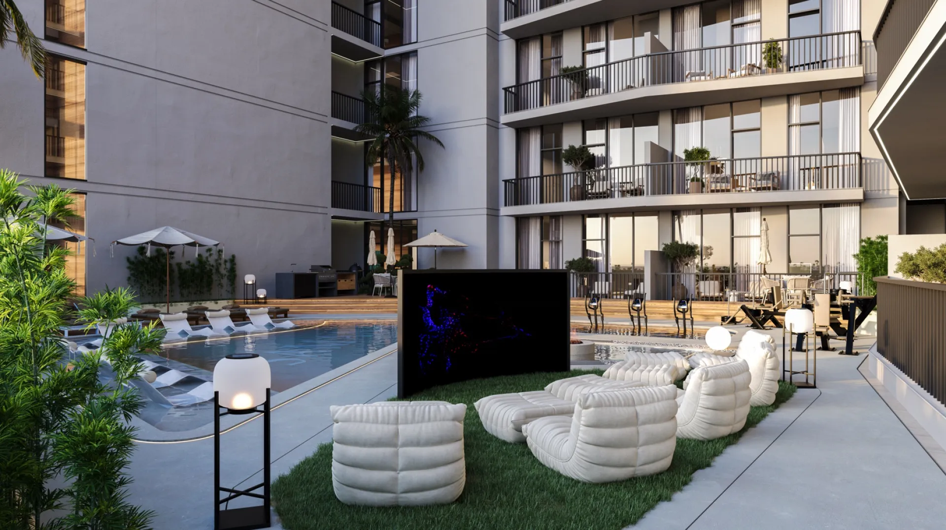 Outdoor cinema lawn beside the pool at SAMANA Greenfield 2