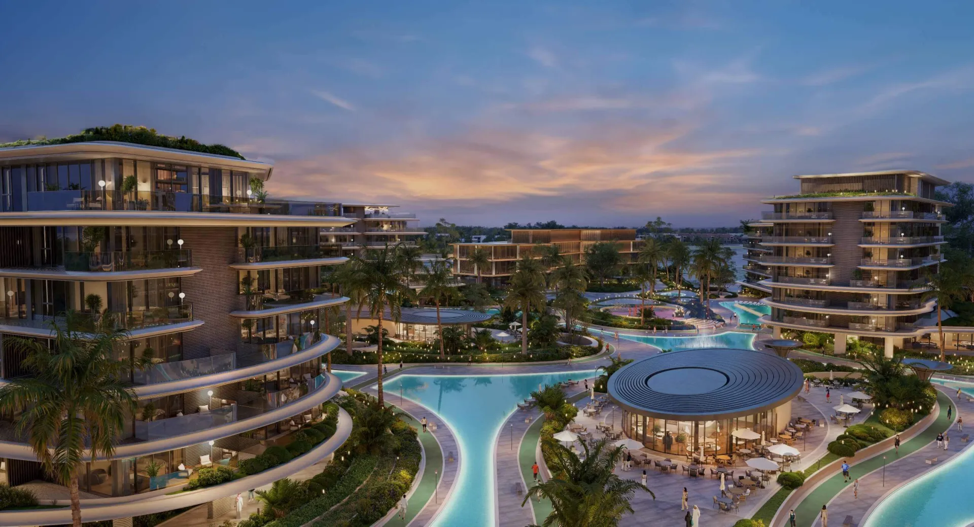 Residential buildings and lagoon-style pools at dusk, developer render